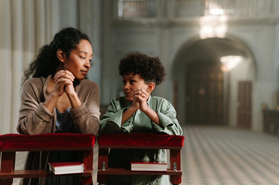 A mother and her child praying in a church
