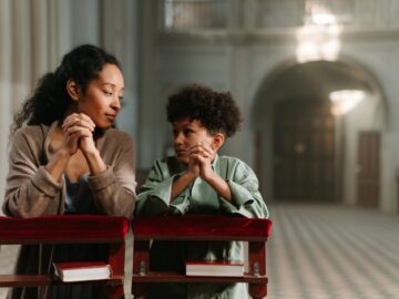 A mother and her child praying in a church